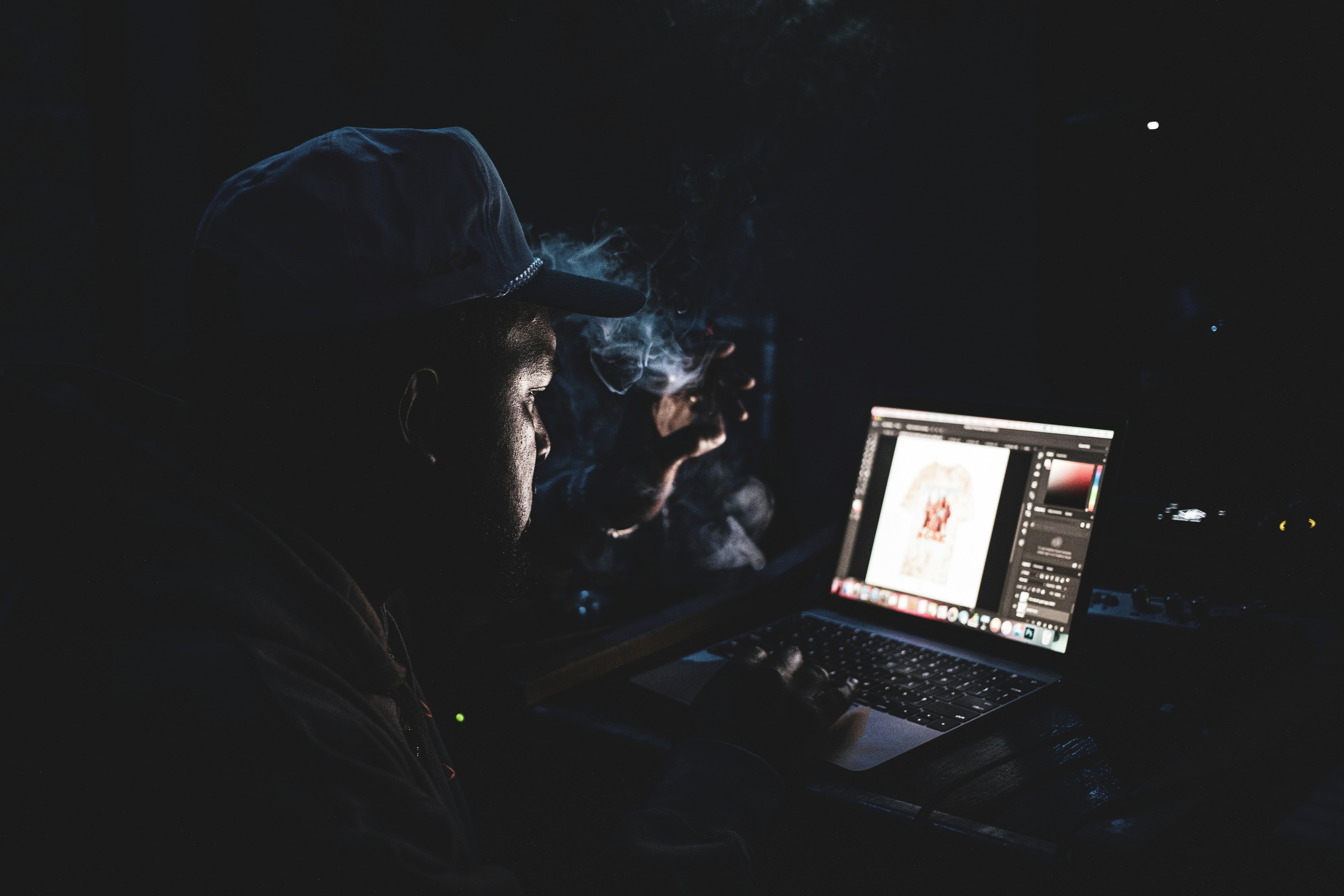 man in black jacket using laptop computer